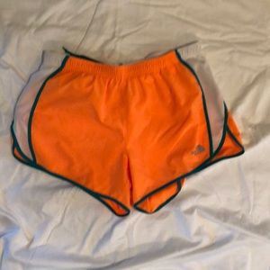 The North Face orange running shorts